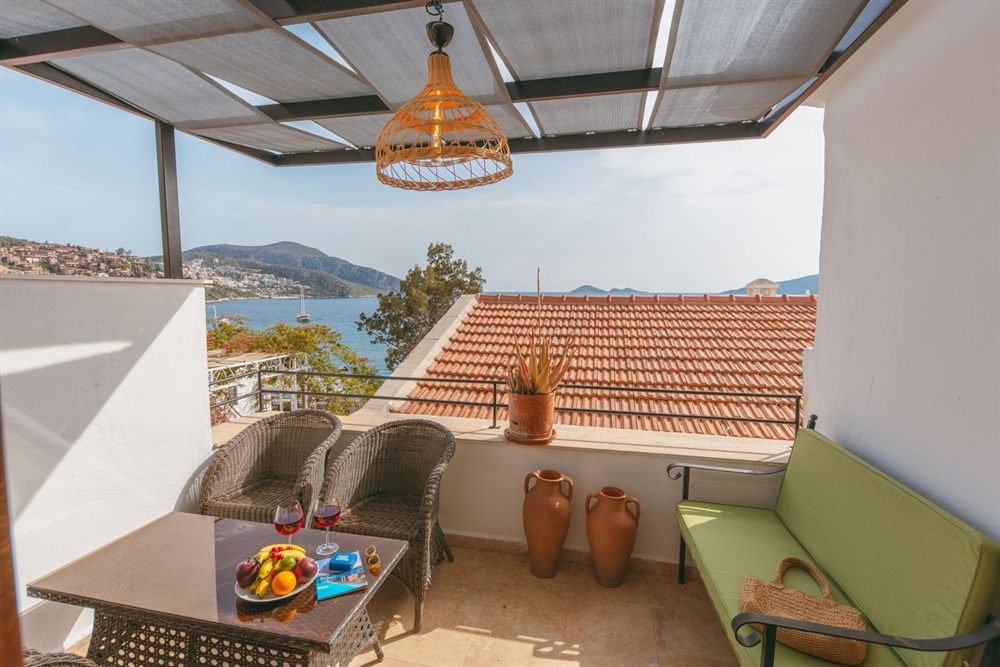 Shaded terrace with sofas and a sea view