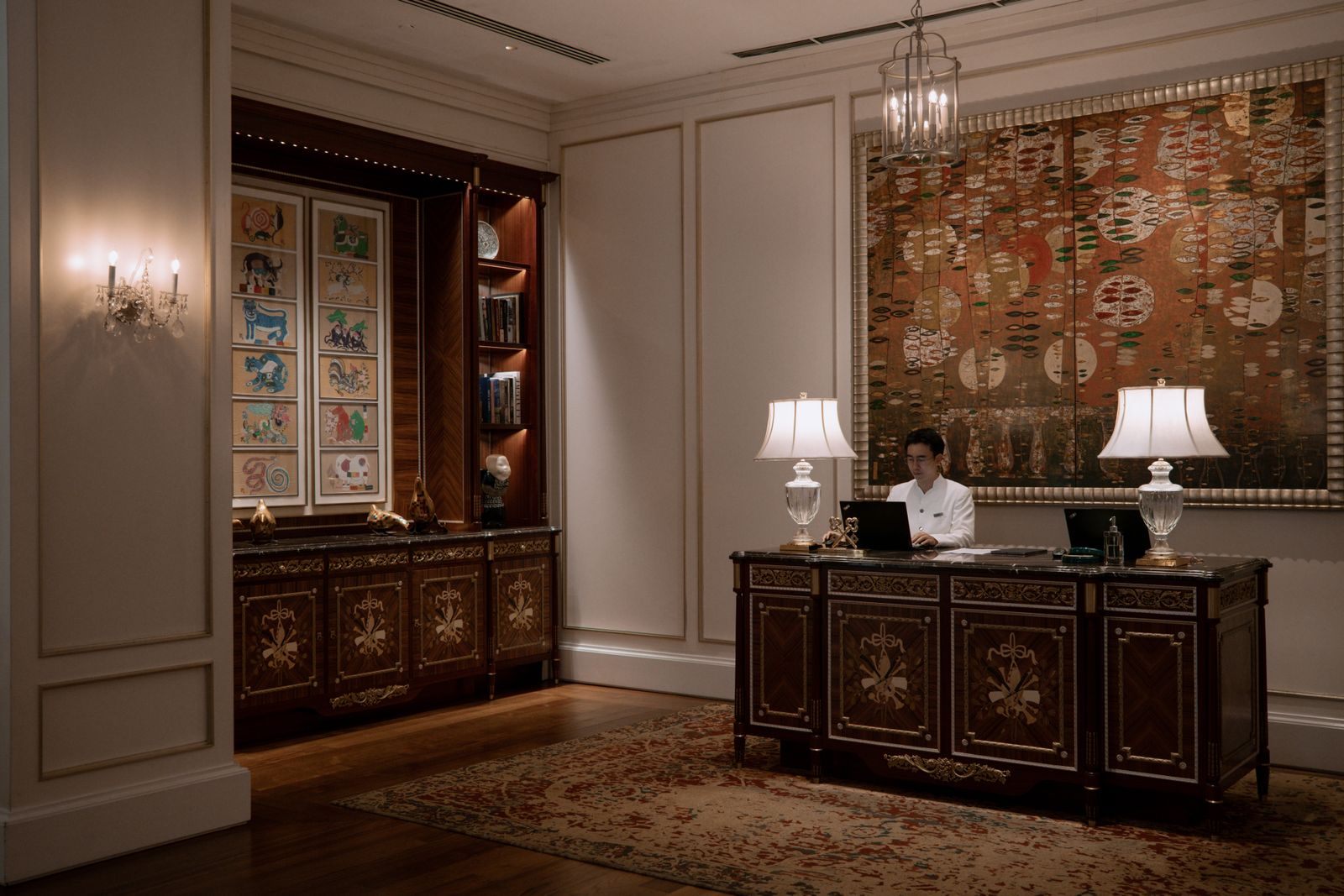 Elegant concierge desk with table lamps in a grand lobby, the kind of service a cruise concierge level brings to sea
